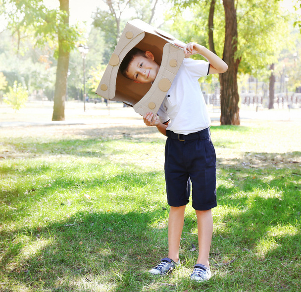 Funny boy in carton helmet  - Foto, afbeelding