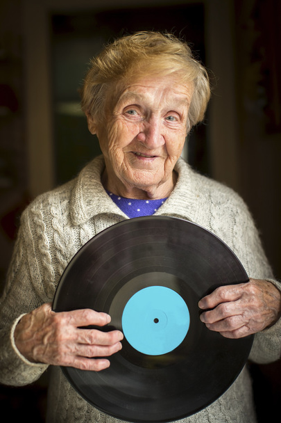 Grandma with Vinyl record disk - Foto, afbeelding
