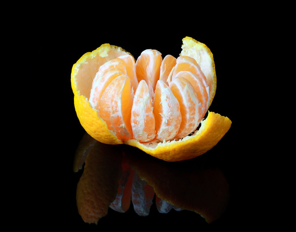 Tangerine on a black background. - Photo, Image