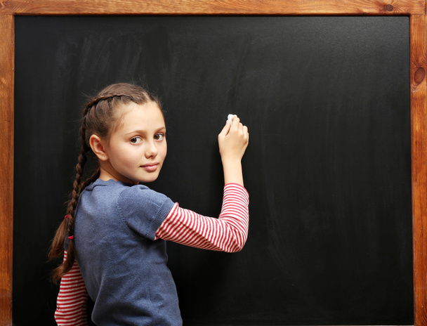 girl posing at clean blackboard - Foto, imagen