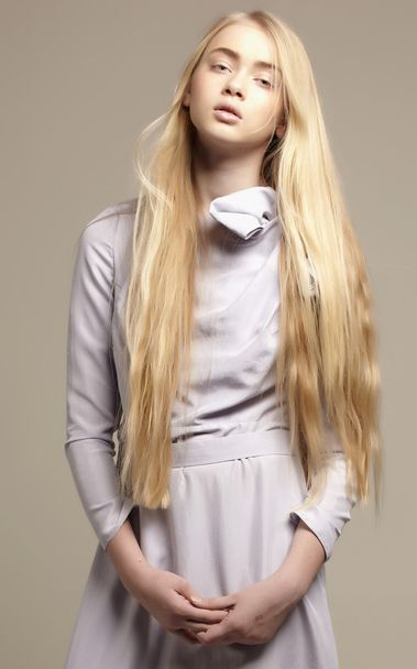 Portrait of a beautiful young girl with long blowing hair and bi - Фото, зображення