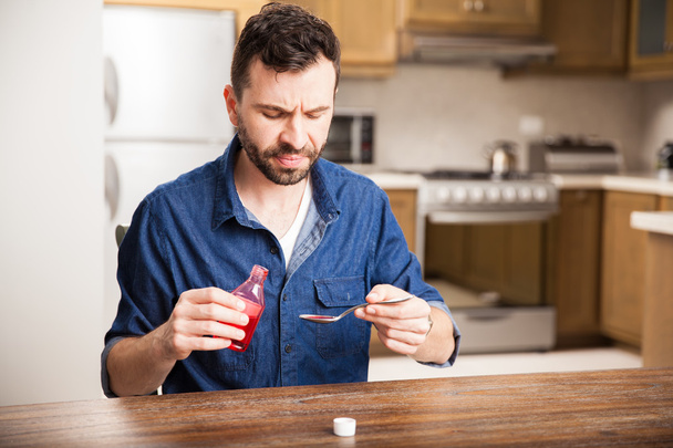 man  holding cough syrup - Photo, image