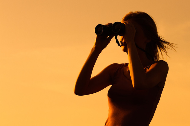 woman in nature looking through binoculars - Фото, зображення