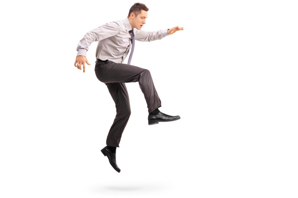 Young businessman jumping in the air  - Fotó, kép