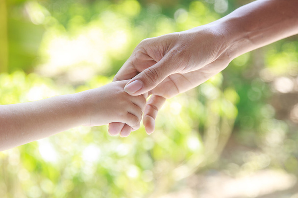 Helping hands  - man holding child hand  - Photo, image