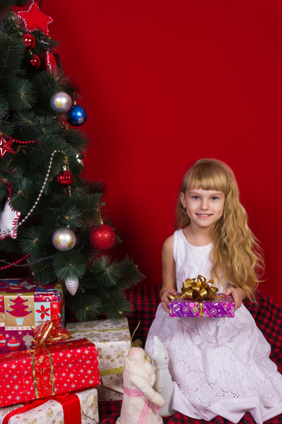 Beautiful baby gir near the Christmas tree in New Year's Eve - Fotografie, Obrázek
