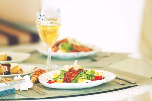 Tasty salad on white served table - 写真・画像
