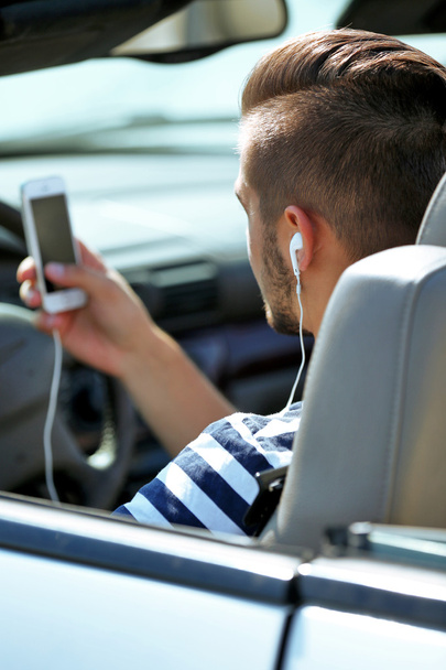 Man with headphones in car - Photo, image