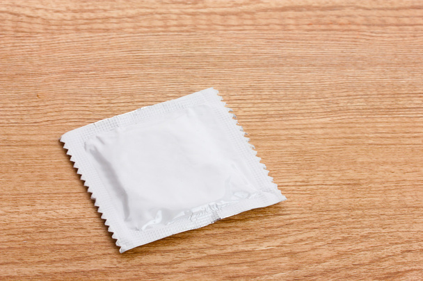 One condom on wooden background - Фото, зображення