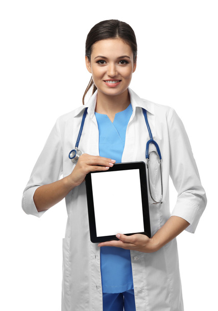 Smiling medical doctor holding a tablet - Valokuva, kuva