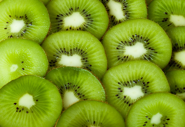 Healthy food background with beautiful green kiwi - Foto, afbeelding