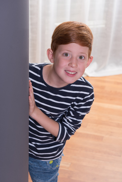 small boy looking from behind a pillar  - Photo, Image