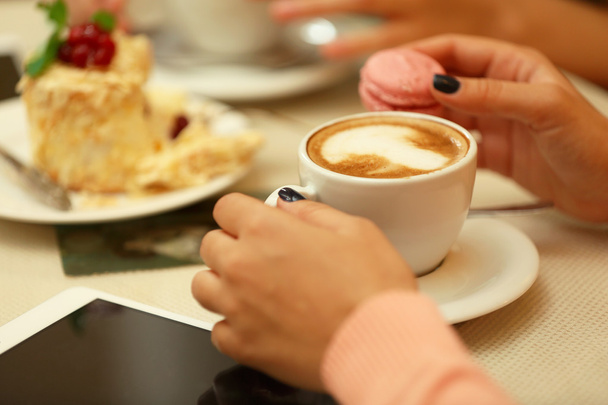 Women meeting in cafe and drinking latte - 写真・画像
