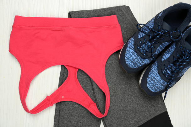 Sport clothes, shoes on light background - 写真・画像