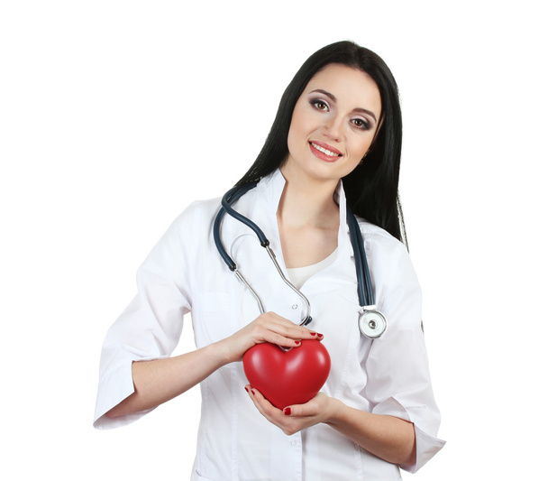 Young beautiful doctor with stethoscope holding heart isolated on white - Foto, Imagen