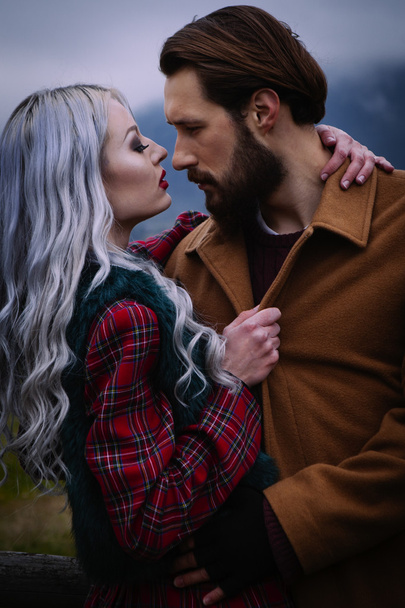 Lov couple in the autumn mountains - Фото, изображение