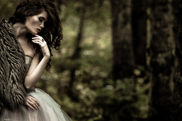 Portrait of romantic woman in beautiful dress in fairy forest - Photo, Image