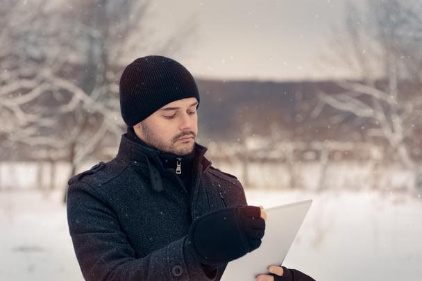 Man with Tablet Outside in Winter Decor - Fotoğraf, Görsel