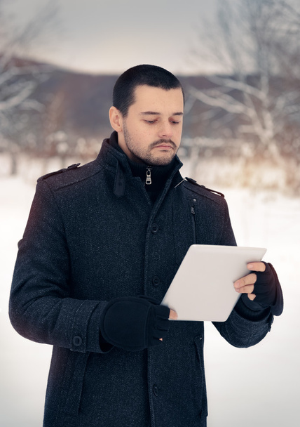 Man with Tablet Outside in Winter Decor - Fotoğraf, Görsel
