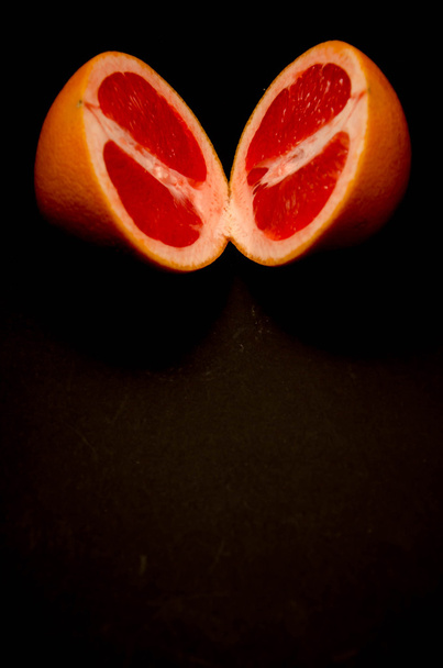 grapefruit, rózsaszín háttérrel - Fotó, kép