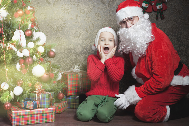 Christmas inspiration! Happy shocked boy surprised to see Santa - Foto, immagini