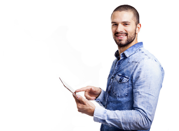 Handsome man pointing to his digital tablet - Foto, immagini
