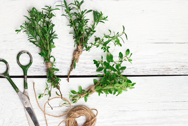 Mix of herbs on a wooden table, savory, thyme - Photo, image