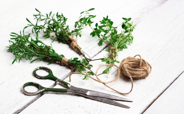 Mix of herbs on a wooden table, savory, thyme - Valokuva, kuva