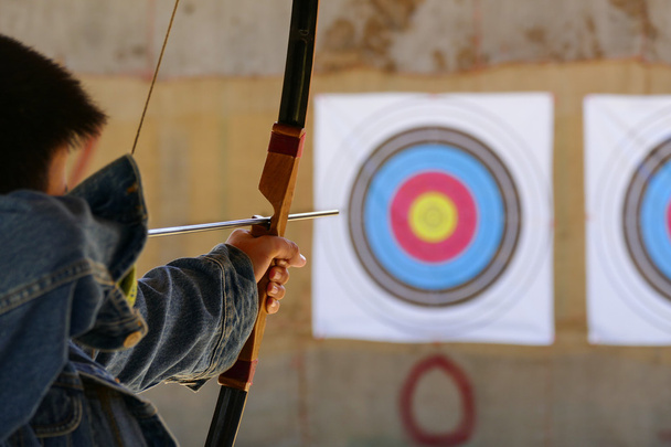 archer is aiming the archery at the target - Photo, Image