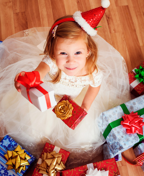 little girl with christmas or birthday presents sitting on the floor - Φωτογραφία, εικόνα