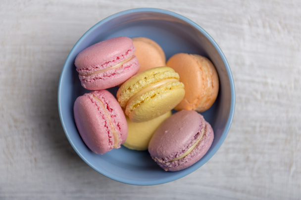 Colorful macarons on vintage pastel background - Fotografie, Obrázek