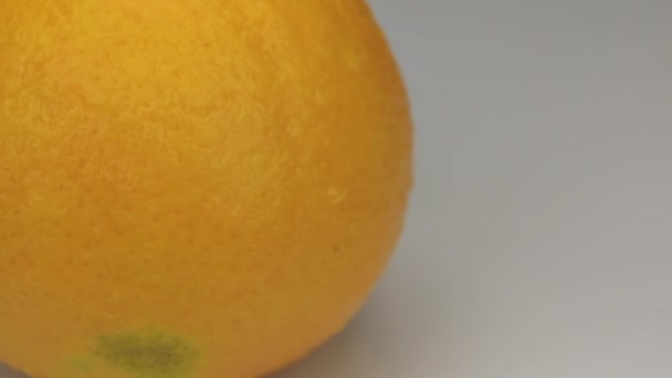 Extreme closeup orange  in drops of dew rotates on its axis. - Video