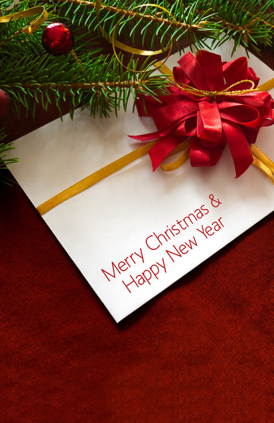 Christmas card or invitation with red envelope surrounded by decorations. Space for copy. - Fotografie, Obrázek