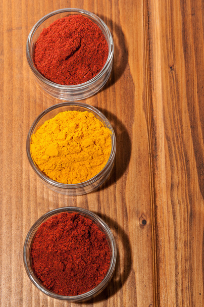 Three bowls with paprika and curry - Photo, Image