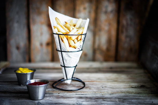 French fries on rustic wooden background - Foto, immagini
