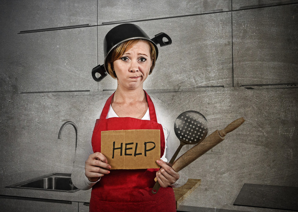 home cook woman confused and frustrated in apron and cooking pot as helmet asking for help - 写真・画像