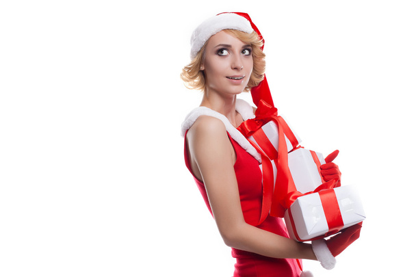 young woman wearing Santa Claus costume holding colorful gift bo - Foto, afbeelding