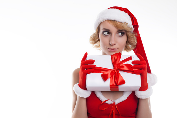beautiful blond young woman wearing Santa Claus costume holding  - Foto, afbeelding