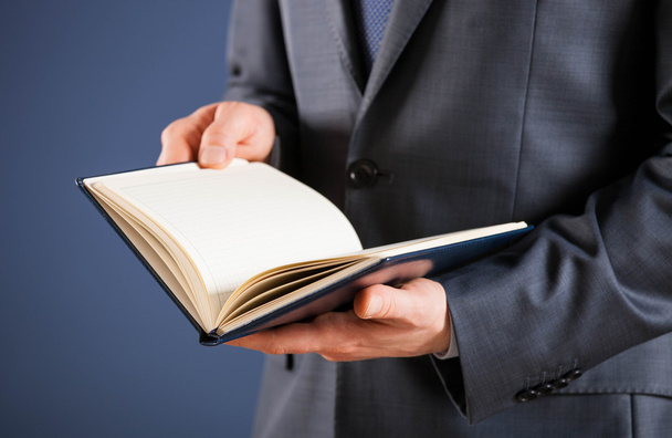 Businessman holding an opened book - Photo, image