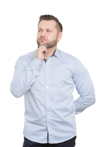 adult male with a beard. isolated on white background. hand behind his back, touching the chin. gesture of thinking and distrust - Foto, Imagen