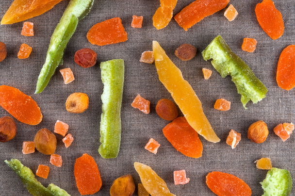 Top view of healthy dried colorful fruits and zucchini cuts on linen fabric cloth background - Photo, image