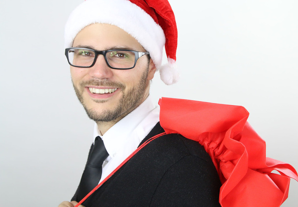 Christmas time - businessman holding a christmas bag - Photo, image