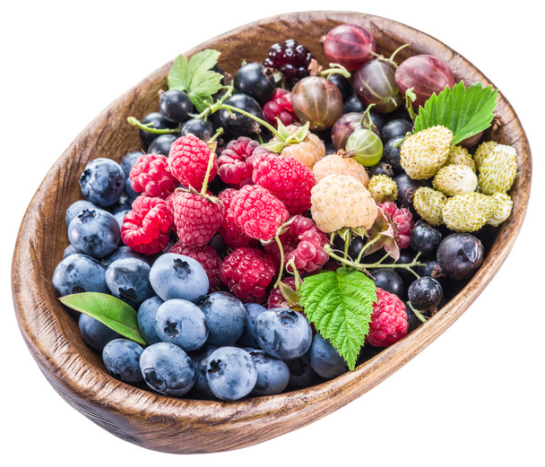 Berries in the wooden bowl on a white.  - Foto, Bild