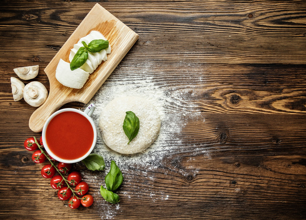 Pizza dough with ingredients on wood - Fotoğraf, Görsel