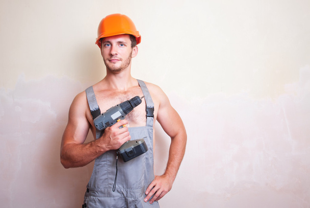 Man in overalls with a screwdriver - Photo, Image