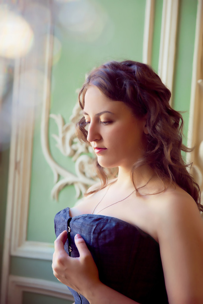 beautiful woman wearing corset posing in  palace - Fotografie, Obrázek