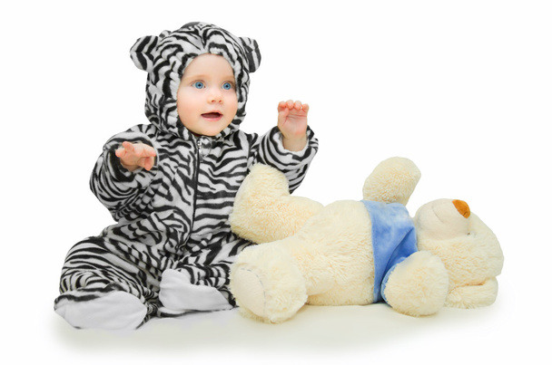 маленькая девочка в полосатом костюме и мягкой игрушке
 - Фото, изображение