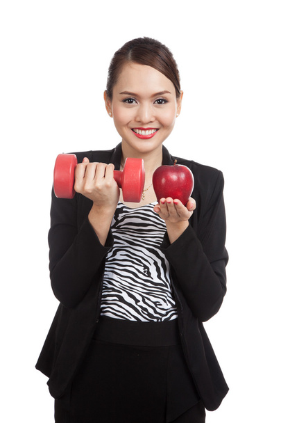 Young Asian business woman with red apple and dumbbells - Foto, imagen