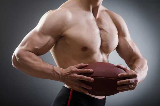 Muscular man with american football - Photo, Image