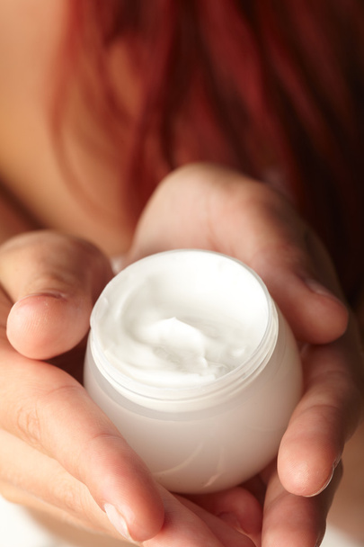 Woman applying cream on her hand - Foto, immagini